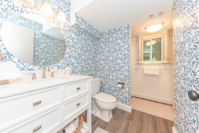 4893 Club Pl, Ypsilanti, MI 48197 - full bathroom featuring wallpapered walls, wood finished floors, and vanity