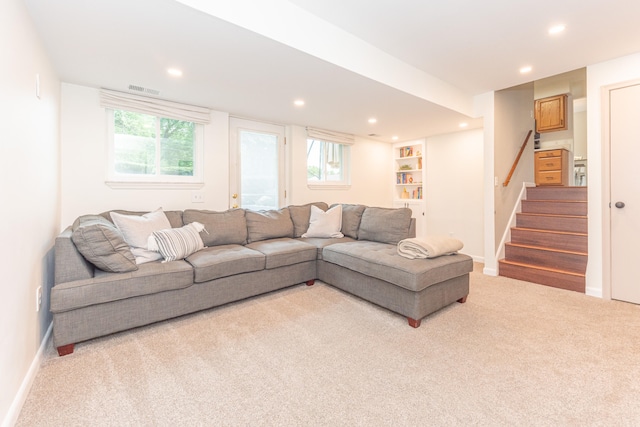 4893 Club Pl, Ypsilanti, MI 48197 - living area with light colored carpet, recessed lighting, stairway, and plenty of natural light