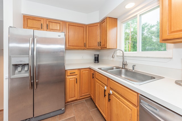 4893 Club Pl, Ypsilanti, MI 48197 - kitchen with stainless steel appliances, light countertops, and light tile patterned floors