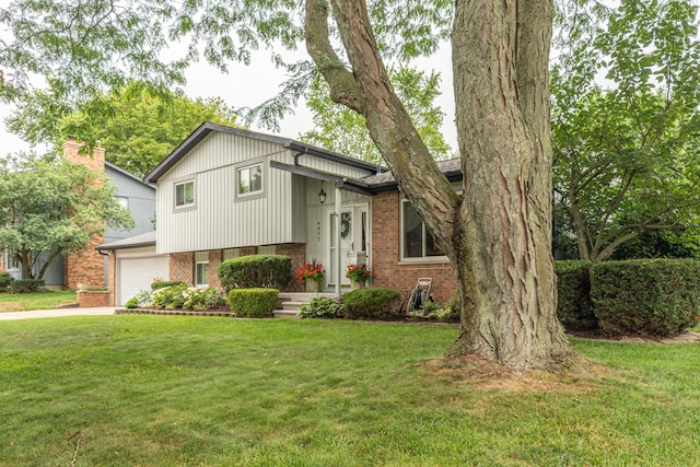 4893 Club Pl, Ypsilanti, MI 48197 - tri-level home with brick siding, a front lawn, and driveway
