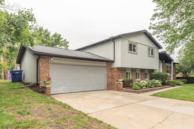 4893 Club Pl, Ypsilanti, MI 48197 - tri-level home featuring brick siding, driveway, a garage, and a front yard