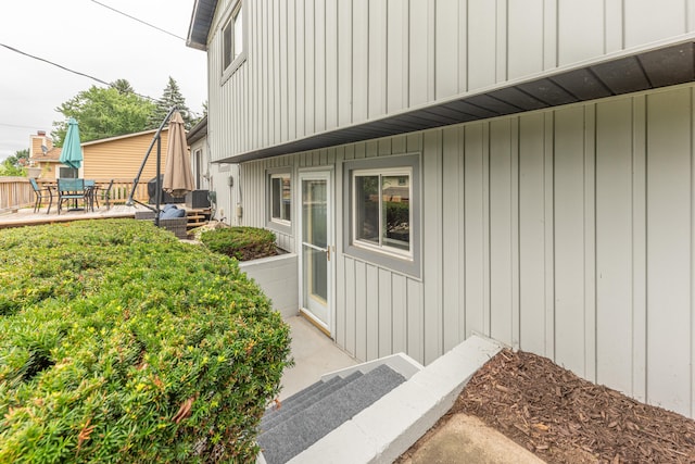 4893 Club Pl, Ypsilanti, MI 48197 - view of property exterior with board and batten siding, outdoor dining area, and a patio area