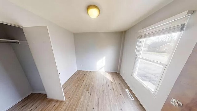 101 E Mckay St, Saline, MI 48176 - unfurnished bedroom with light wood-style floors and a closet