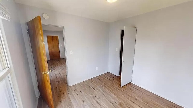 101 E Mckay St, Saline, MI 48176 - spare room with light wood finished floors and a smoke detector