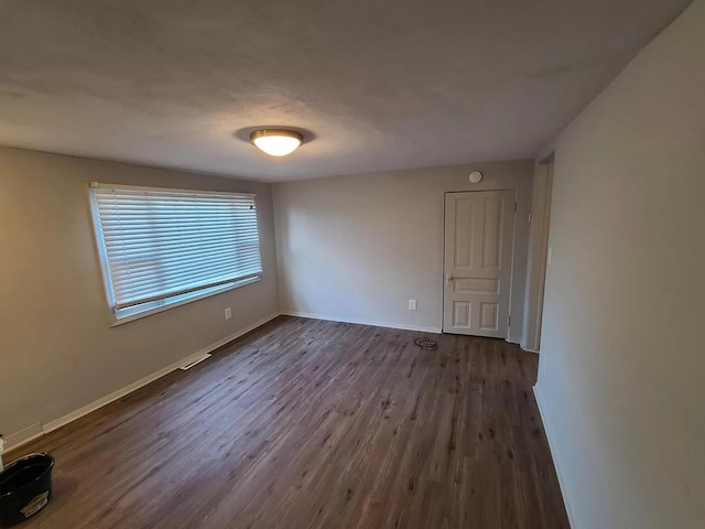 101 E Mckay St, Saline, MI 48176 - unfurnished room with dark wood-style floors and baseboards