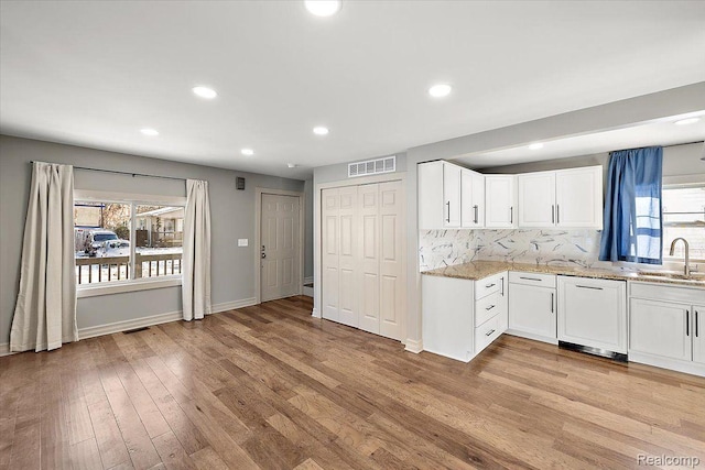 20817 Parkside Blvd, Ferndale, MI 48220 - kitchen with paneled dishwasher, light stone counters, white cabinetry, backsplash, and recessed lighting
