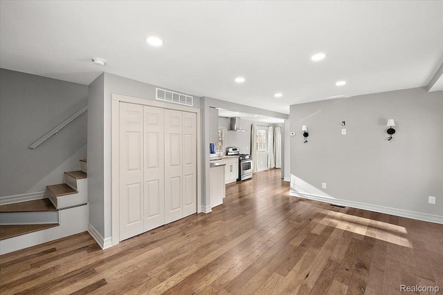 20817 Parkside Blvd, Ferndale, MI 48220 - unfurnished living room featuring stairway, wood finished floors, and recessed lighting