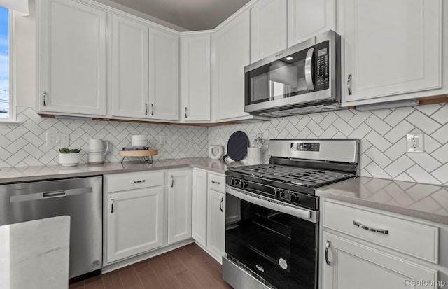 3056 Sheffield Cir, Clarkston, MI 48346 - kitchen featuring stainless steel appliances, white cabinets, decorative backsplash, and dark wood-style flooring