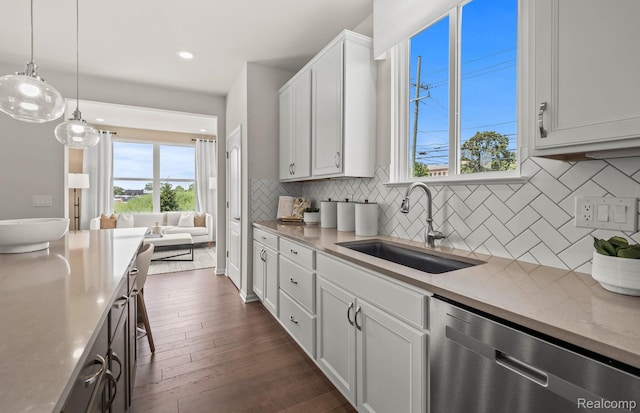 3056 Sheffield Cir, Clarkston, MI 48346 - kitchen with dishwasher, dark wood-style floors, white cabinetry, hanging light fixtures, and backsplash