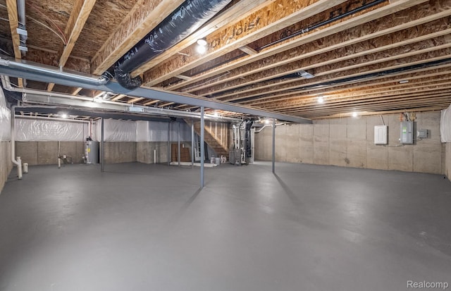 3056 Sheffield Cir, Clarkston, MI 48346 - unfinished below grade area featuring gas water heater, electric panel, and stairway