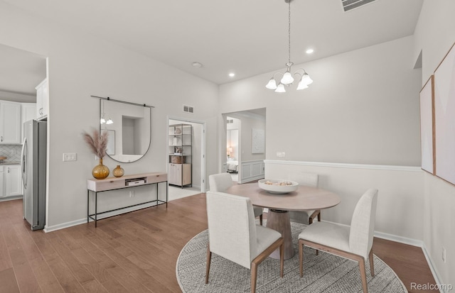 3056 Sheffield Cir, Clarkston, MI 48346 - dining space featuring a chandelier, wood finished floors, and recessed lighting