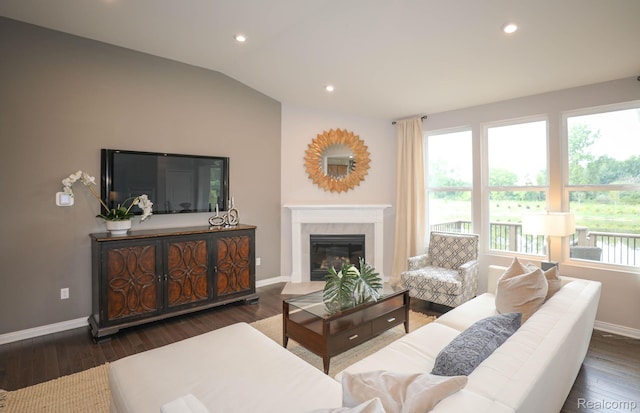 3056 Sheffield Cir, Clarkston, MI 48346 - living room featuring healthy amount of natural light, wood finished floors, vaulted ceiling, a tiled fireplace, and recessed lighting