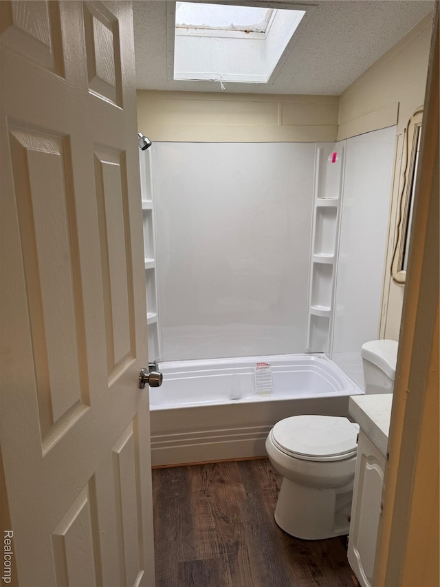 2445 E Grand River Ave, Lot, Williamston, MI 48895 - bathroom with a skylight, wood finished floors, vanity, and shower / washtub combination