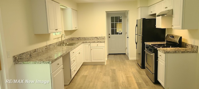 4404 Eastport Dr, Bridgeport, MI 48722 - kitchen with gas stove, under cabinet range hood, light wood finished floors, and white cabinetry