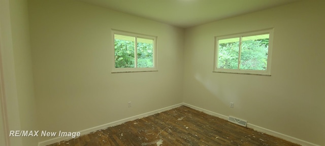 4404 Eastport Dr, Bridgeport, MI 48722 - empty room with plenty of natural light and dark wood-style floors