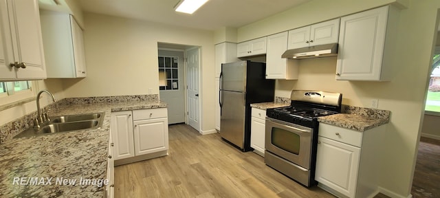 4404 Eastport Dr, Bridgeport, MI 48722 - kitchen with stainless steel appliances, under cabinet range hood, light wood-style floors, and white cabinetry