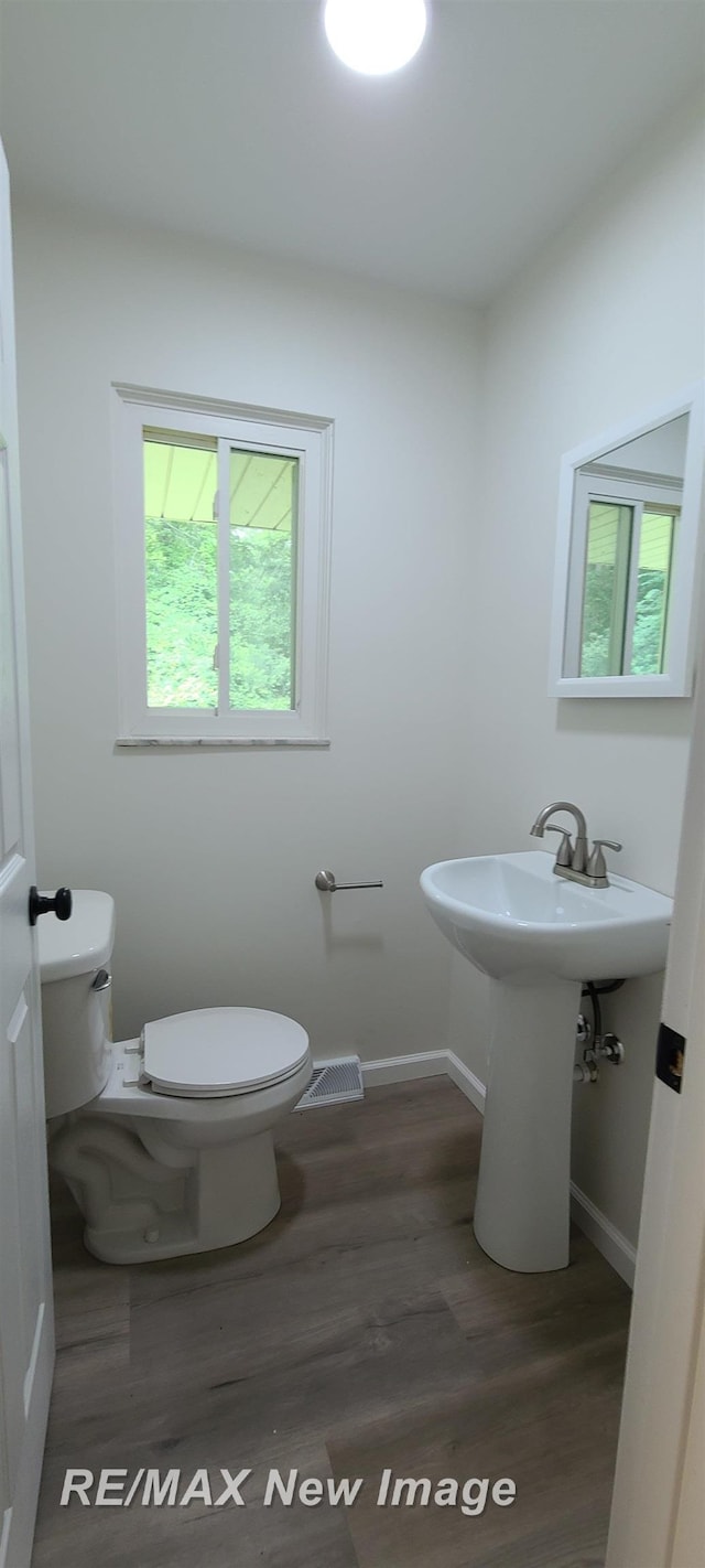 4404 Eastport Dr, Bridgeport, MI 48722 - half bath featuring toilet and wood finished floors