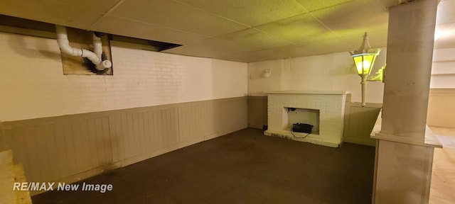 4404 Eastport Dr, Bridgeport, MI 48722 - finished basement featuring a wainscoted wall, a drop ceiling, and a fireplace