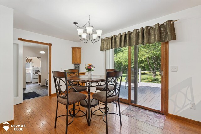 416 State Park Rd, Ortonville, MI 48462 - dining space featuring light wood-type flooring, a chandelier, and washer / dryer
