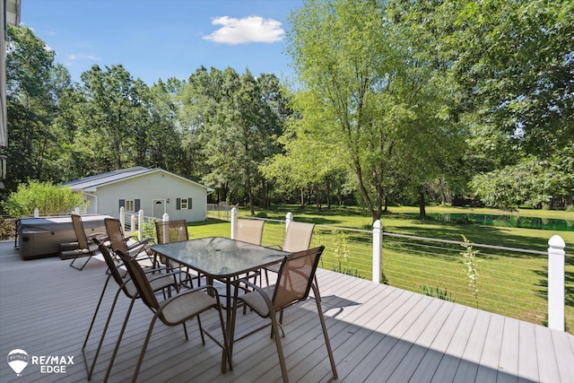 416 State Park Rd, Ortonville, MI 48462 - wooden terrace with a hot tub, outdoor dining space, a lawn, view of wooded area, and a water view