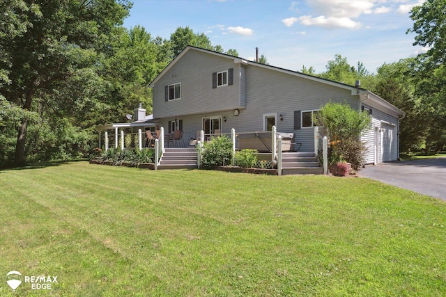 416 State Park Rd, Ortonville, MI 48462 - view of front facade with a deck, asphalt driveway, a front lawn, and an attached garage