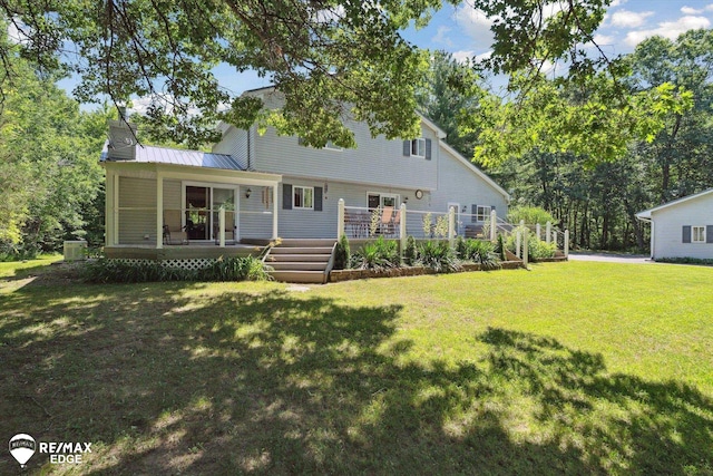416 State Park Rd, Ortonville, MI 48462 - view of front facade featuring a front yard, a wooden deck, and a metal roof