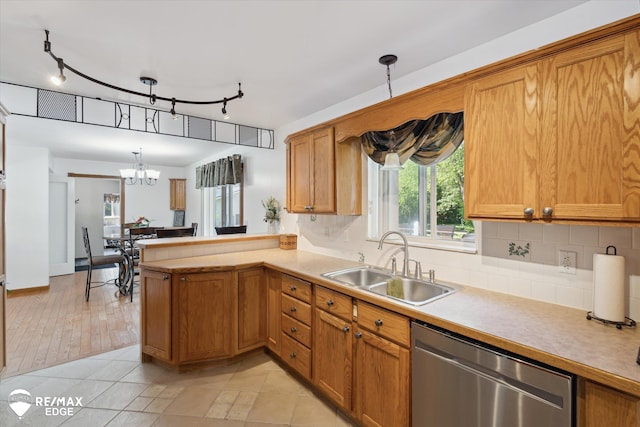 416 State Park Rd, Ortonville, MI 48462 - kitchen featuring stainless steel dishwasher, light countertops, backsplash, a chandelier, and a peninsula