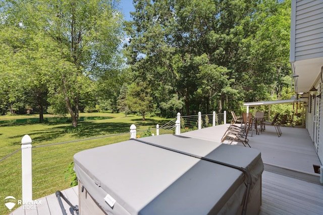416 State Park Rd, Ortonville, MI 48462 - wooden terrace featuring outdoor dining space, a hot tub, a yard, and view of wooded area