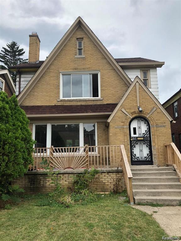 16651 Lawton St, Detroit, MI 48221 - tudor house with brick siding, a chimney, and a front yard