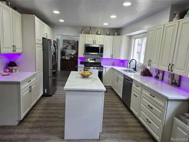 17328 Mcnamara Dr, Garden City, MI 48152 - kitchen featuring appliances with stainless steel finishes, a center island, recessed lighting, dark wood-style floors, and light stone counters