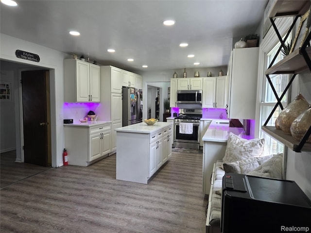 17328 Mcnamara Dr, Garden City, MI 48152 - kitchen with appliances with stainless steel finishes, light countertops, wood finished floors, a center island, and white cabinets