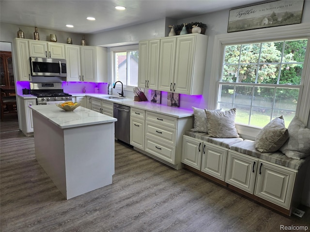 17328 Mcnamara Dr, Garden City, MI 48152 - kitchen with stainless steel appliances, wood finished floors, a center island, recessed lighting, and white cabinetry