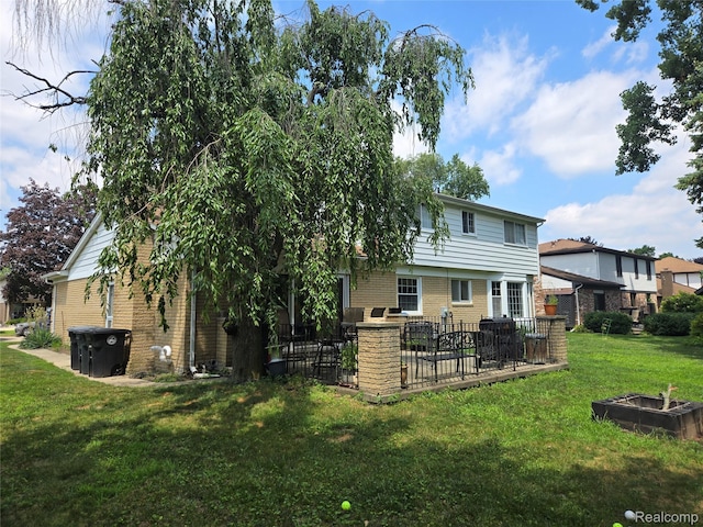 17328 Mcnamara Dr, Garden City, MI 48152 - back of house with a lawn, brick siding, and a patio area