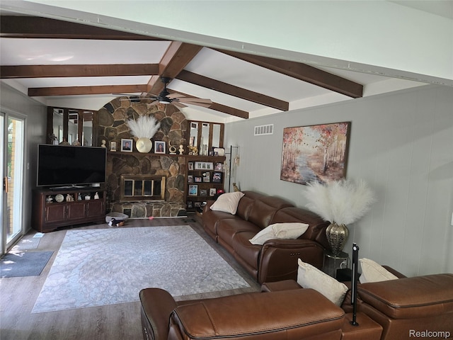 17328 Mcnamara Dr, Garden City, MI 48152 - living area with wood finished floors, ceiling fan, and a stone fireplace