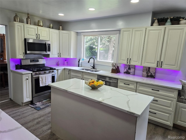17328 Mcnamara Dr, Garden City, MI 48152 - kitchen featuring stainless steel appliances, light stone counters, dark wood-style flooring, recessed lighting, and a center island