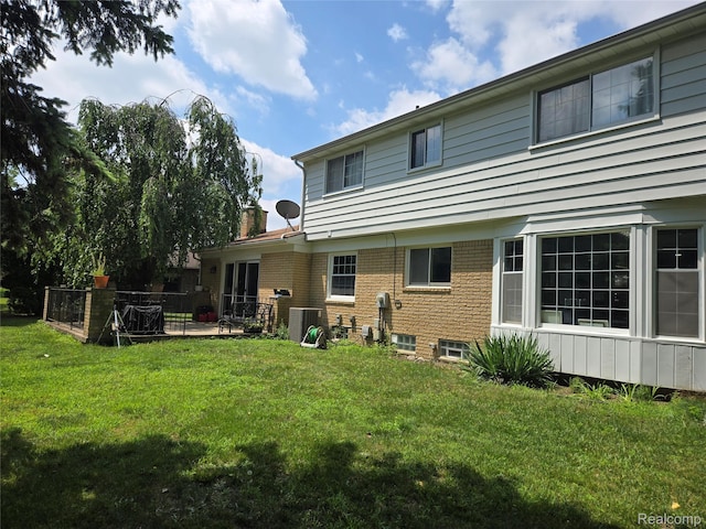 17328 Mcnamara Dr, Garden City, MI 48152 - rear view of property with a yard, brick siding, and a chimney