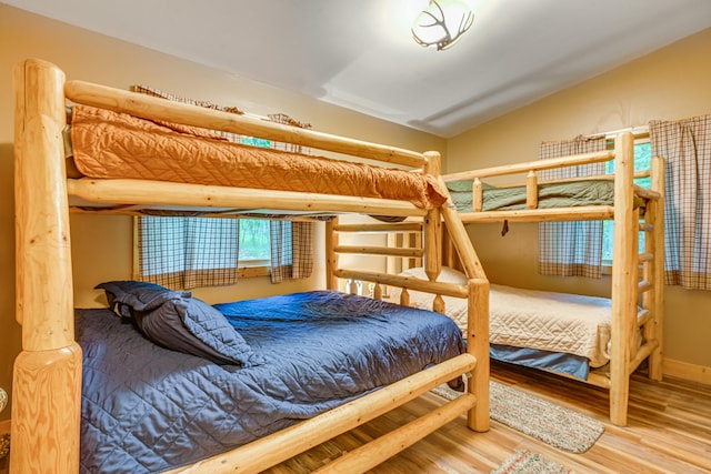 5154 Cherry Rd, Farwell, MI 48622 - bedroom featuring wood finished floors and lofted ceiling
