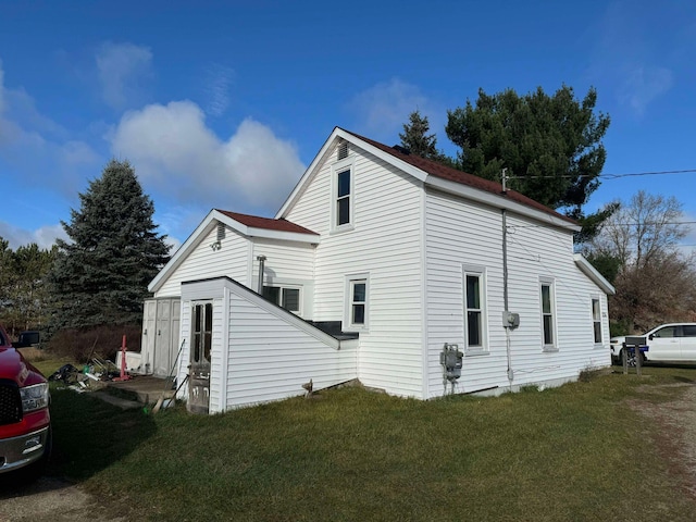 524 S Cherry St, Evart, MI 49631 - view of home's exterior with a lawn