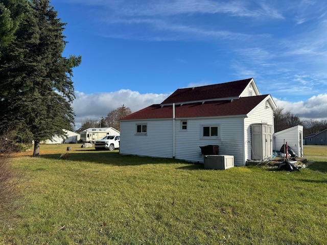 524 S Cherry St, Evart, MI 49631 - view of side of property featuring a lawn