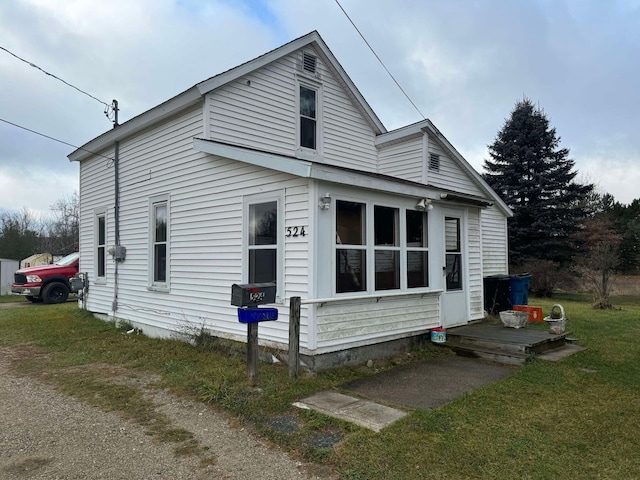 524 S Cherry St, Evart, MI 49631 - view of side of home with a yard