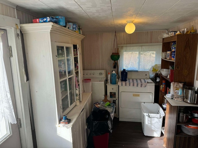 524 S Cherry St, Evart, MI 49631 - kitchen featuring dark wood-style floors, wood walls, light countertops, open shelves, and washing machine and dryer