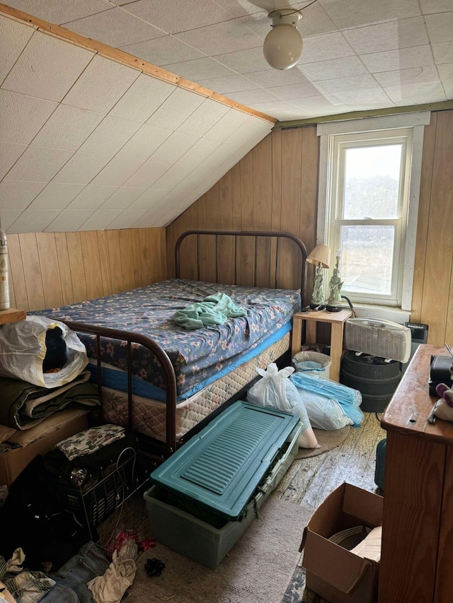 524 S Cherry St, Evart, MI 49631 - bedroom with wooden walls, lofted ceiling, and carpet flooring