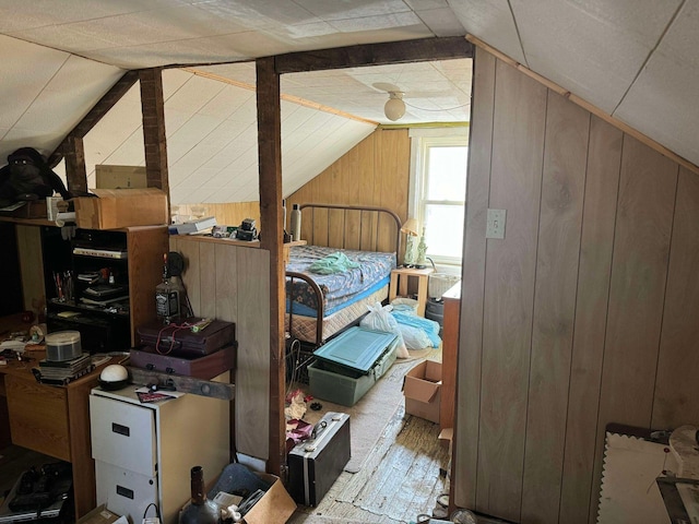 524 S Cherry St, Evart, MI 49631 - bedroom featuring wooden walls, vaulted ceiling, and wood finished floors