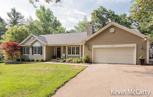530 Pine Haven Dr, Comstock Park, MI 49321 - ranch-style house with asphalt driveway, a chimney, a garage, and a front lawn