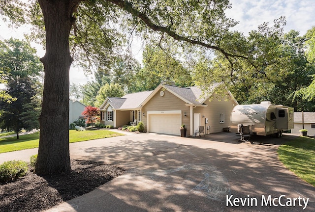 530 Pine Haven Dr, Comstock Park, MI 49321 - ranch-style house featuring an attached garage, driveway, and a front lawn