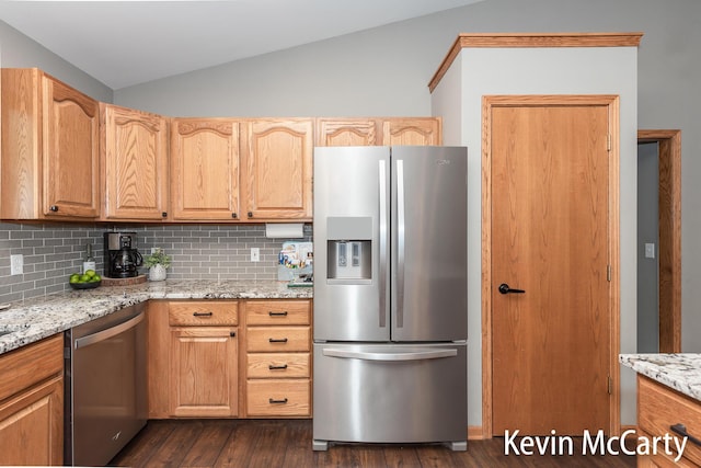 530 Pine Haven Dr, Comstock Park, MI 49321 - kitchen with appliances with stainless steel finishes, lofted ceiling, decorative backsplash, dark wood-type flooring, and light stone counters