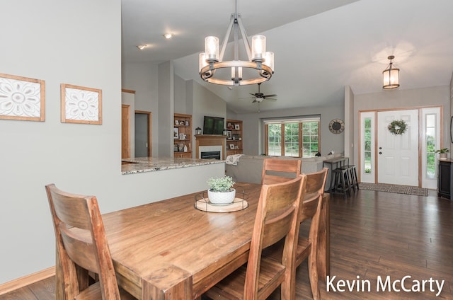 530 Pine Haven Dr, Comstock Park, MI 49321 - dining area featuring a chandelier, vaulted ceiling, wood finished floors, and a ceiling fan
