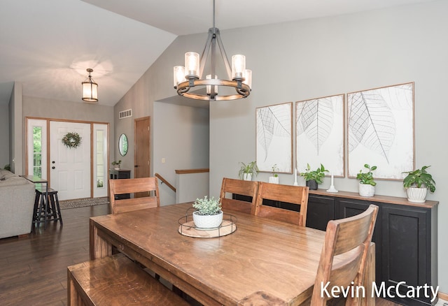 530 Pine Haven Dr, Comstock Park, MI 49321 - dining space featuring a chandelier, vaulted ceiling, and dark wood finished floors