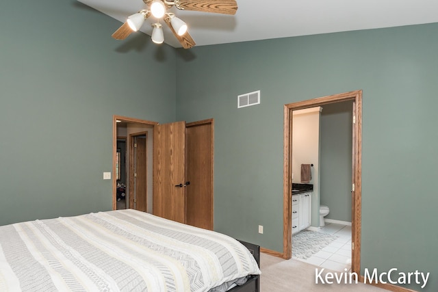 530 Pine Haven Dr, Comstock Park, MI 49321 - bedroom featuring light tile patterned flooring, ensuite bath, a ceiling fan, a closet, and high vaulted ceiling