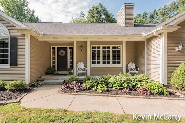 530 Pine Haven Dr, Comstock Park, MI 49321 - doorway to property featuring a chimney and covered porch